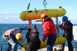 Team placing the AUV Lucille on deck after a mission